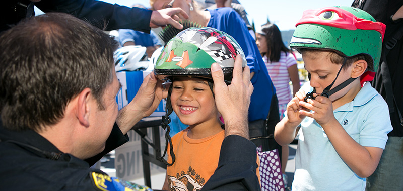 Officer adjusting bike helmet