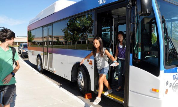 students getting off of a bus