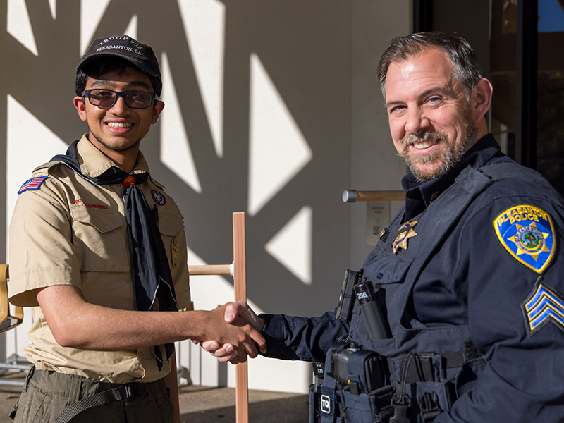 police shaking hands with a volunteer