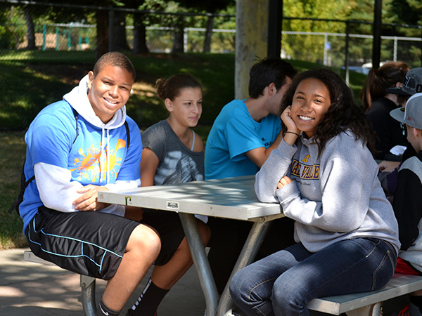 teens smiling at a table